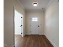 Bright and airy foyer with wood-look flooring and a white front door at 1328 Bethlehem Church Rd, Youngsville, NC 27596