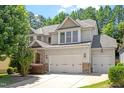 Charming two-story home with a three car garage and manicured landscaping at 1413 Lily Creek Dr, Cary, NC 27518