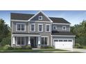 Charming two-story home showcasing a well-manicured lawn and attached garage at 1500 Wader Cir, Knightdale, NC 27545