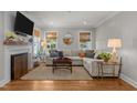 Inviting living room with hardwood floors, a fireplace, and ample natural light at 1811 Ridley St, Raleigh, NC 27608