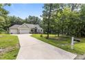 Inviting home with a long driveway, well-maintained lawn, and beautifully landscaped surroundings at 186 Ross Dr, Pittsboro, NC 27312