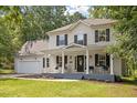 Beautiful two-story home with a classic front porch, rocking chairs, and a well-maintained lawn and landscaping at 1990 Ferbow St, Creedmoor, NC 27522