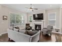 Inviting living room boasts a fireplace, large windows, and hardwood floors at 220 W Winmore Ave, Chapel Hill, NC 27516