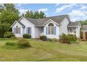 Inviting home featuring neat landscaping, complementary blue shutters, and architectural details at 2312 Buckstone Ct, Fuquay Varina, NC 27526