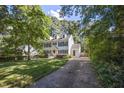Traditional two-story home with blue shutters on a large lot, with a long driveway at 2409 Basil Dr, Raleigh, NC 27612