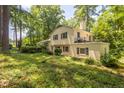 Backyard view of home with a balcony and lush, green surroundings at 256 Marilyn Cir, Cary, NC 27513