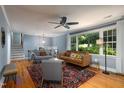 Bright living room with hardwood floors, large windows, and comfortable seating at 256 Marilyn Cir, Cary, NC 27513