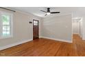 Bright living room featuring hardwood floors and a modern ceiling fan at 2609 Elmhurst Cir, Raleigh, NC 27610