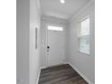 Bright entryway with wood-look flooring, white walls, and natural light at 273 Millennium Dr, Pittsboro, NC 27312