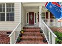 Inviting front porch with brick steps and colorful flower pots creating a welcoming entrance at 2750 Michelle Ct, Creedmoor, NC 27522