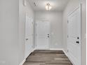 Bright foyer with hardwood floors, neutral walls, and multiple white doors at 287 White Oak Ridge Dr, Garner, NC 27529