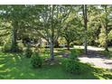 Landscaped home featuring mature trees and an expansive lawn at 3005 Piney Grove Wilbon Rd, Holly Springs, NC 27540