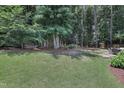 Lush, green backyard featuring mature trees for privacy at 3058 Hyco Lake Ct, Fuquay Varina, NC 27526