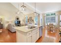Open concept kitchen with island seating flows to dining and living room, perfect for entertaining at 3058 Hyco Lake Ct, Fuquay Varina, NC 27526