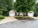 Inviting home featuring neutral siding, green shutters, attached garages, and a spacious front yard at 3652 E Cotton Gin Dr, Clayton, NC 27527