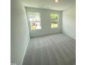 Cozy bedroom with plush carpeting and bright windows offering plenty of natural light at 369 Thompson Overlook Way, Smithfield, NC 27577