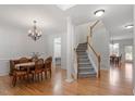 Elegant foyer featuring hardwood floors, staircase and classic chandelier at 3921 Robins Nest Ln, Wake Forest, NC 27587