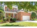 Beautiful two-story brick home featuring an attached two car garage and covered front porch at 3921 Robins Nest Ln, Wake Forest, NC 27587