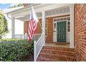 Inviting front porch with brick steps and a beautiful green front door at 3921 Robins Nest Ln, Wake Forest, NC 27587