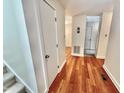 Bright hallway with hardwood floors, connecting various rooms in this well-maintained condo at 406 Fairoaks Cir, Chapel Hill, NC 27516