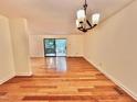 Spacious living room with natural light and hardwood floors, ideal for entertaining and relaxation at 406 Fairoaks Cir, Chapel Hill, NC 27516