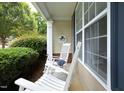 Cozy front porch featuring white rocking chairs, a welcome sign, and stylish decor at 4224 Vienna Crest Drive Dr, Raleigh, NC 27613