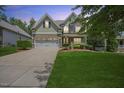 Charming two-story home with a well-manicured lawn and a two-car garage at dusk at 4229 Cats Paw Ct, Wake Forest, NC 27587