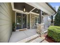 Inviting front porch with stone pillars and a cozy seating area at 4229 Cats Paw Ct, Wake Forest, NC 27587