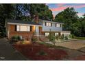Charming two-story home with a brick facade, white trim, and landscaped yard at 4404 Susan Dr, Raleigh, NC 27603