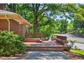 Outdoor deck offering a relaxed space for seating and enjoying the surrounding landscape, complete with a wooden bench at 503 Tarleton Ave, Burlington, NC 27215
