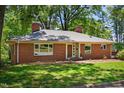 Attractive red brick home with mature trees, beautiful lawn, and ample natural light, creating a welcoming exterior at 503 Tarleton Ave, Burlington, NC 27215