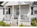 Close up of the covered front porch with swing and seating at 506 Currin St, Durham, NC 27703