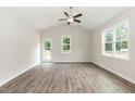 Bright living room features luxury vinyl plank flooring, a ceiling fan, and access to an outdoor deck at 510 Branch St, Rocky Mount, NC 27801