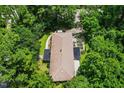 Overhead view of a well maintained home, surrounded by mature trees, offers seclusion and shade at 5301 Thayer Dr, Raleigh, NC 27612