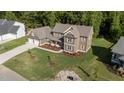 Overhead shot of craftsman home with three car garage, complemented by lush landscaping at 543 Allessandra Dr, Clayton, NC 27527