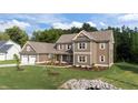 Lovely two-story home with professionally landscaped front yard, new sod and plantings at 543 Allessandra Dr, Clayton, NC 27527
