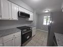 Modern kitchen features stainless steel appliances and granite countertops at 5893 Shady Grove Cir, Raleigh, NC 27609