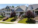 Inviting two-story home with well-manicured lawn, colorful flowerbeds, and a welcoming front porch at 690 Great Ridge Pkwy, Chapel Hill, NC 27516