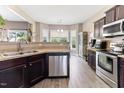 Well-lit kitchen features stainless steel appliances and wood-look flooring at 767 Omaha Dr, Broadway, NC 27505