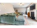 Spacious living room with a fireplace, plush sectional, and wood-look floors at 767 Omaha Dr, Broadway, NC 27505