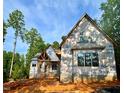 Exterior view of a two-story home under construction showing framing and window placement at 8 Pin Tail Ct, Pittsboro, NC 27312