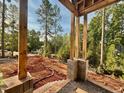 Covered front porch under construction, highlighting exposed framing and a view of the yard at 8 Pin Tail Ct, Pittsboro, NC 27312