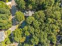 Aerial view of a home nestled among lush green trees at 8412 Old Deer Trl, Raleigh, NC 27615