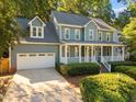 Two-story home with an attached garage, covered porch and manicured landscaping at 8412 Old Deer Trl, Raleigh, NC 27615