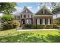 Charming brick home with manicured landscaping, black shutters, and a welcoming front entrance at 9021 Winged Thistle Ct, Raleigh, NC 27617