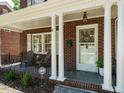 Inviting front porch featuring classic columns, seating, and an ADT security sign at 907 W Johnson St, Raleigh, NC 27605