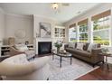 Comfortable living room featuring a fireplace, built-in shelves, and large windows at 915 Chapanoke Rd, Raleigh, NC 27603