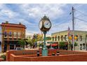 Historic downtown clock surrounded by vintage brick buildings and American flags at 9172 Dupree Meadow Dr # 16, Angier, NC 27501