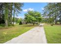 Beautiful single story brick home with mature trees and a long private drive in established neighborhood at 100 Martindale Dr, Youngsville, NC 27596