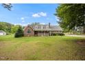 Traditional brick home with dormer windows, inviting front porch and a large front yard at 100 Martindale Dr, Youngsville, NC 27596